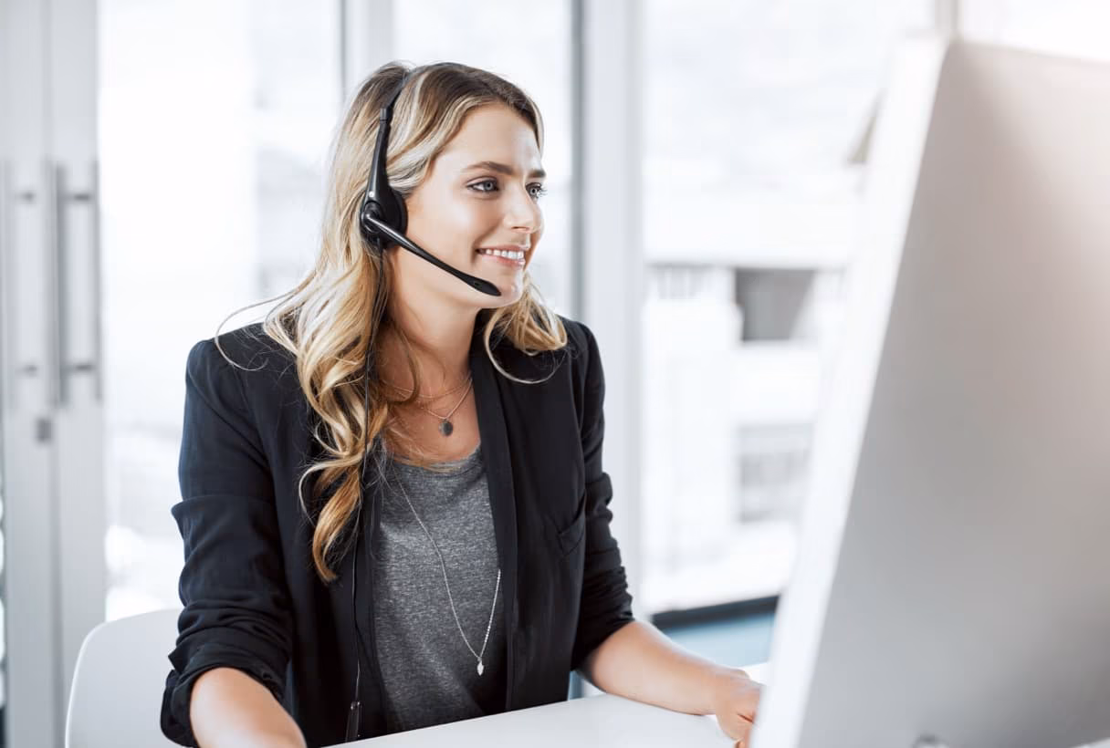 Female at desk with computer and headset